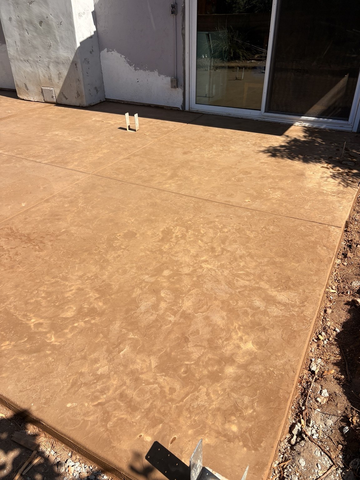 Tan textured concrete patio — Pete and Sons Concrete Inc.