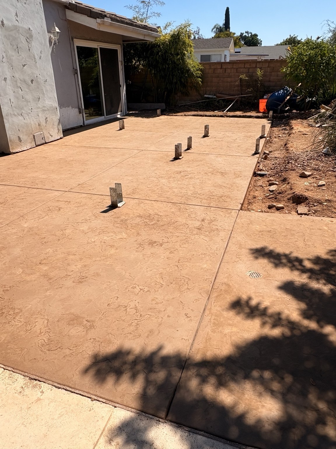 Tan textured concrete patio — Pete and Sons Concrete Inc.