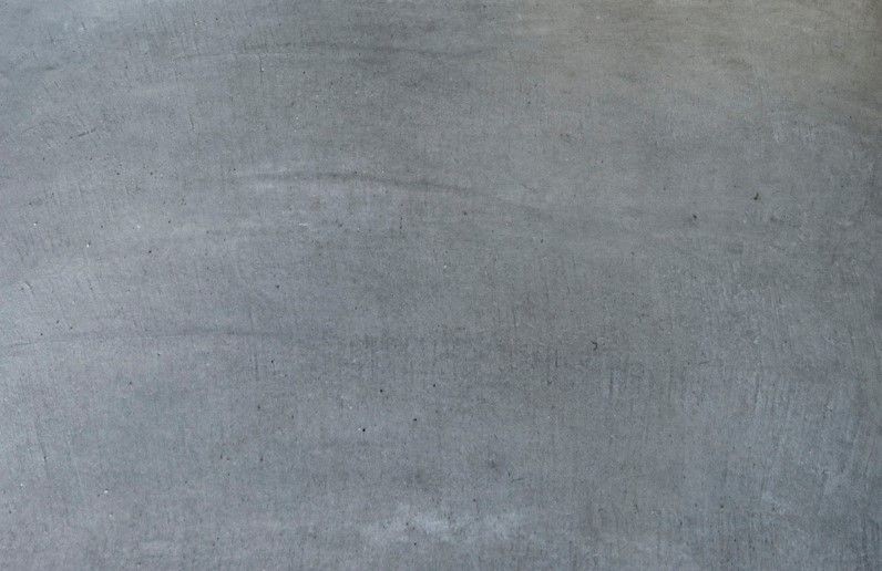 Actual smooth gray steel-troweled concrete surface