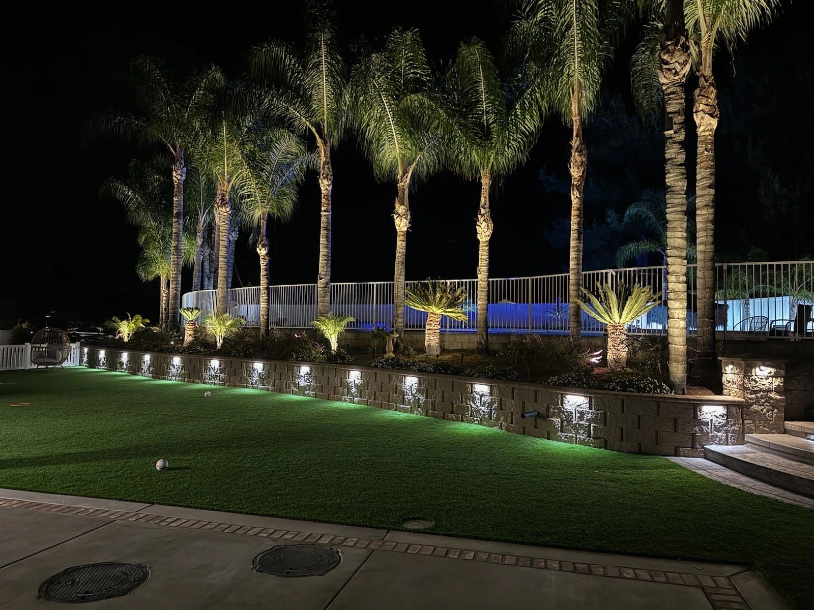 Backyard with decorative paving and landscape lighting